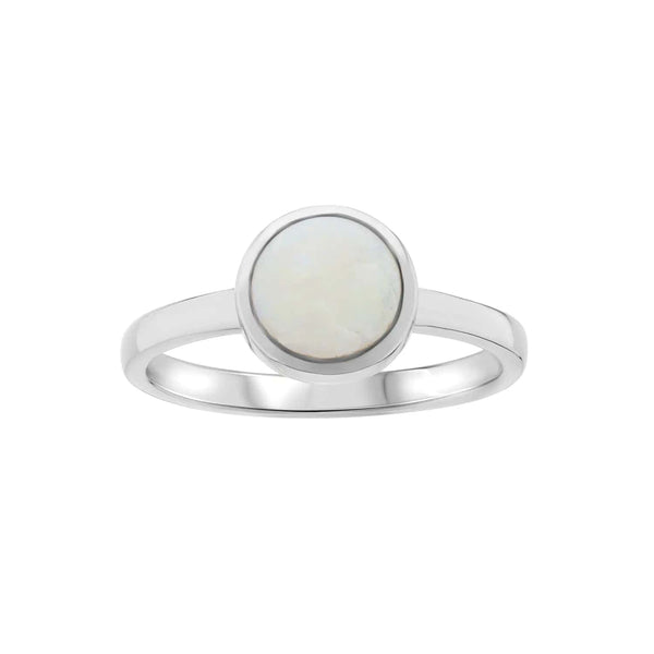 A minimalist white gold ring featuring a smooth round moonstone set in a sleek bezel setting, exuding elegance and simplicity against a plain background.