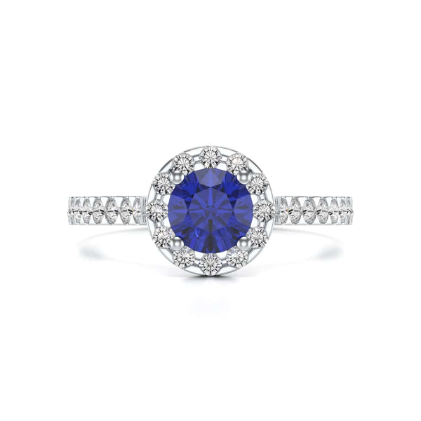 Elegant white gold ring in side profile, adorned with a central blue gemstone and small diamonds along the band, exuding sophistication and luxury.