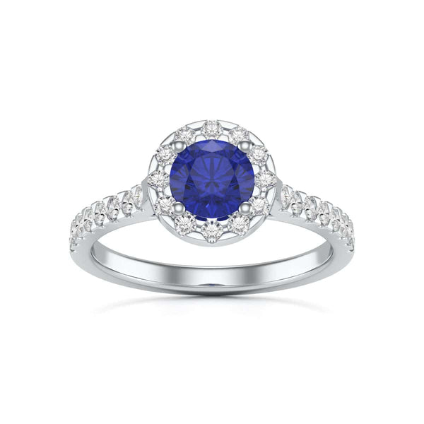 Elegant white gold ring in side profile, adorned with a central blue gemstone and small diamonds along the band, exuding sophistication and luxury.