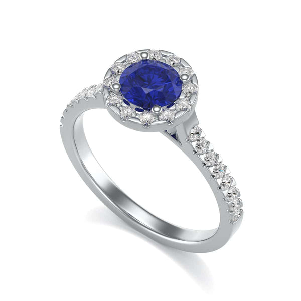 Elegant white gold ring in side profile, adorned with a central blue gemstone and small diamonds along the band, exuding sophistication and luxury.