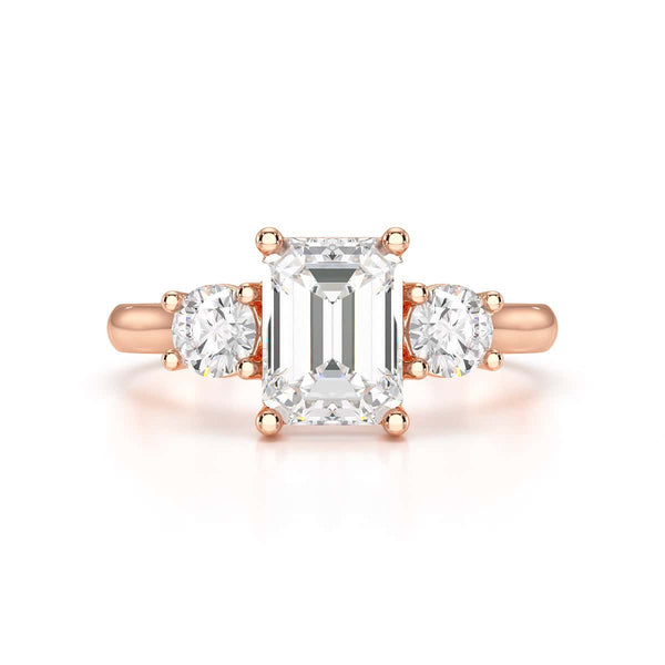 Emerald trilogy Engagement Ring with round side stone