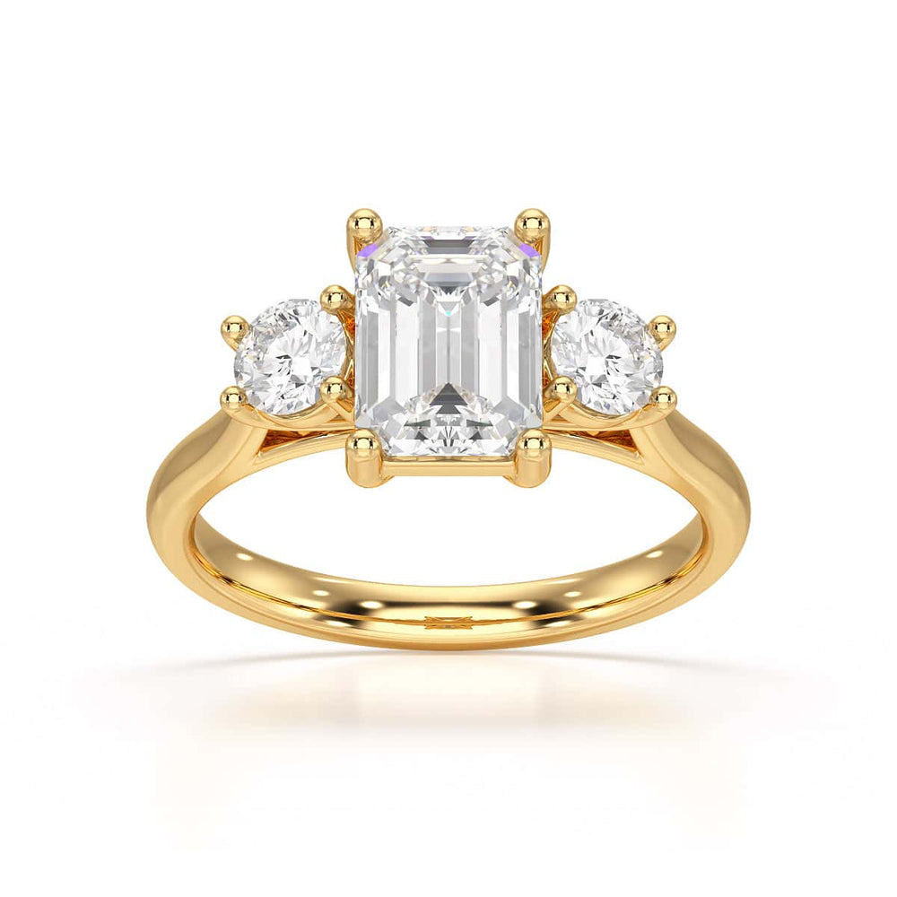 Emerald trilogy Engagement Ring with round side stone