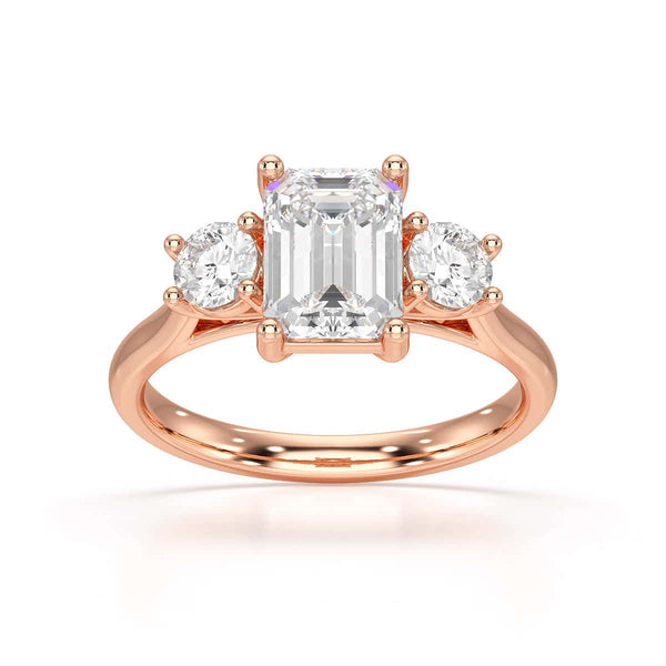 Emerald trilogy Engagement Ring with round side stone