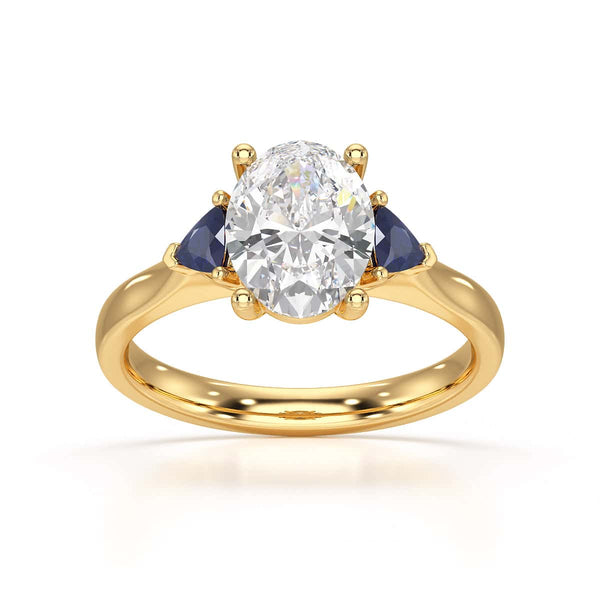Oval trilogy engagement ring with trillion shaped blue sapphire side stones