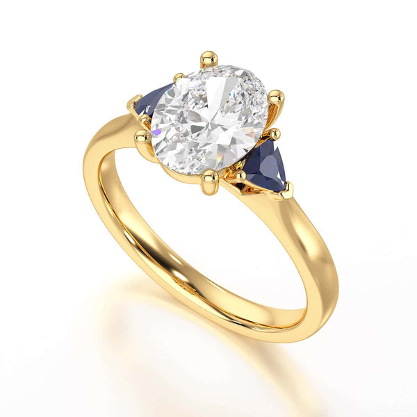 Oval trilogy engagement ring with trillion shaped blue sapphire side stones