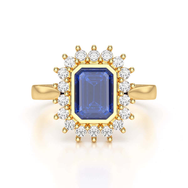 Elegant gold ring with a blue gemstone in a detailed crown setting, viewed from the side, highlighting its intricate design and luxury.