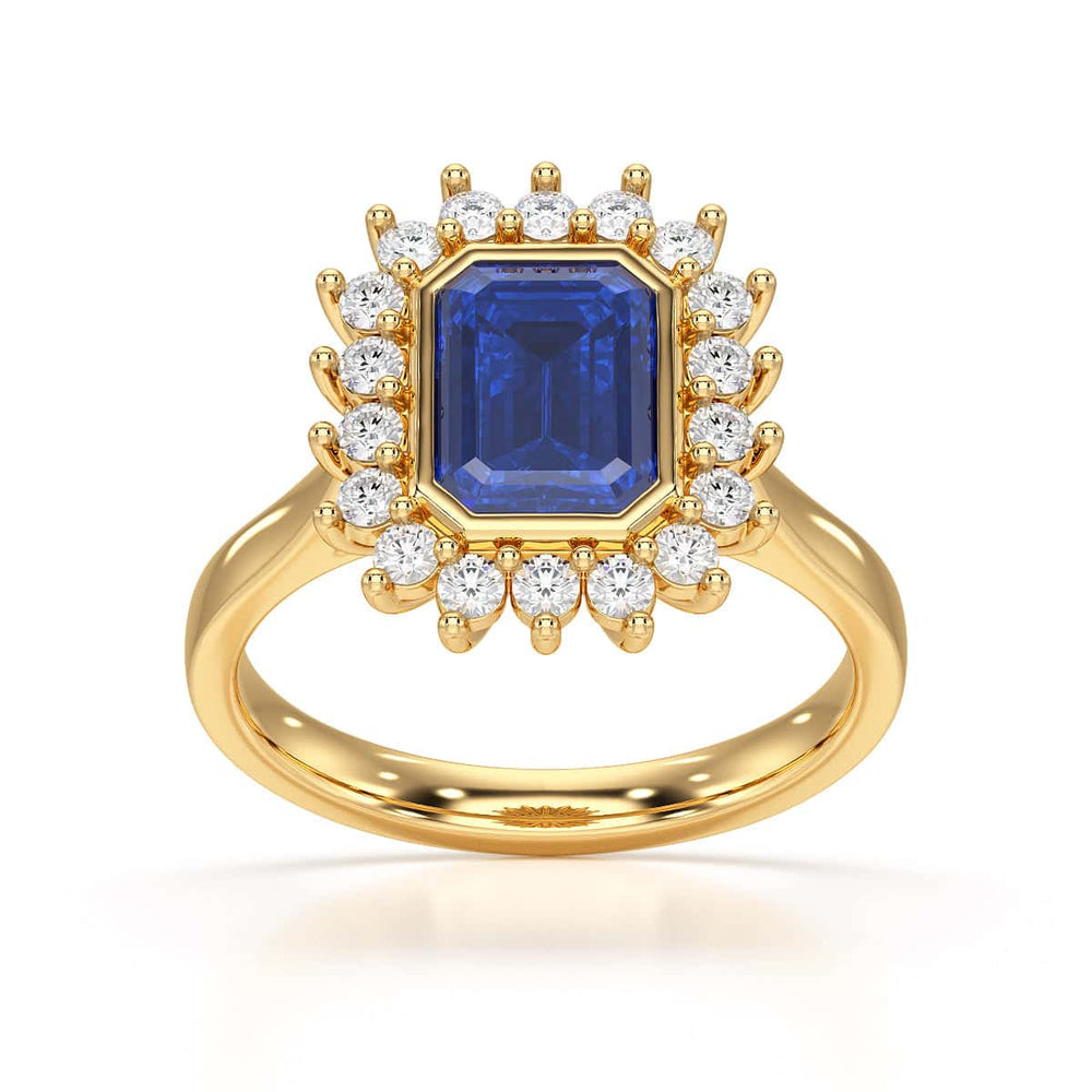 Elegant gold ring with a blue gemstone in a detailed crown setting, viewed from the side, highlighting its intricate design and luxury.