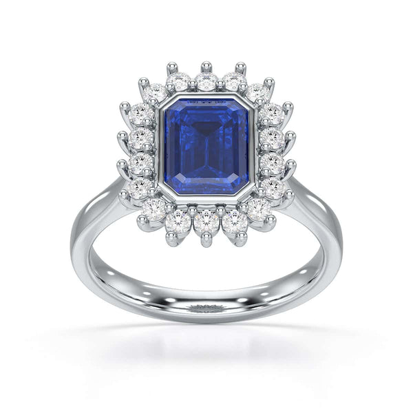 Elegant gold ring with a blue gemstone in a detailed crown setting, viewed from the side, highlighting its intricate design and luxury.
