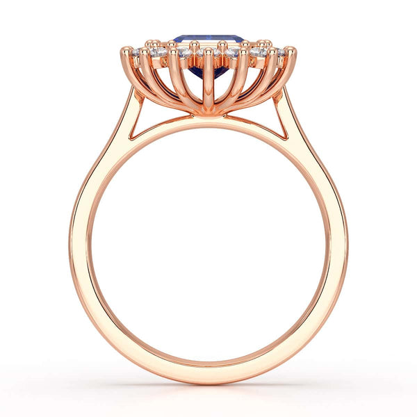 Elegant gold ring with a blue gemstone in a detailed crown setting, viewed from the side, highlighting its intricate design and luxury.