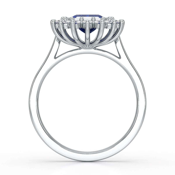 Elegant gold ring with a blue gemstone in a detailed crown setting, viewed from the side, highlighting its intricate design and luxury.