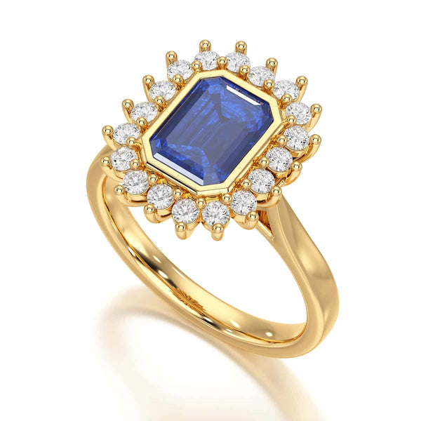 Elegant gold ring with a blue gemstone in a detailed crown setting, viewed from the side, highlighting its intricate design and luxury.