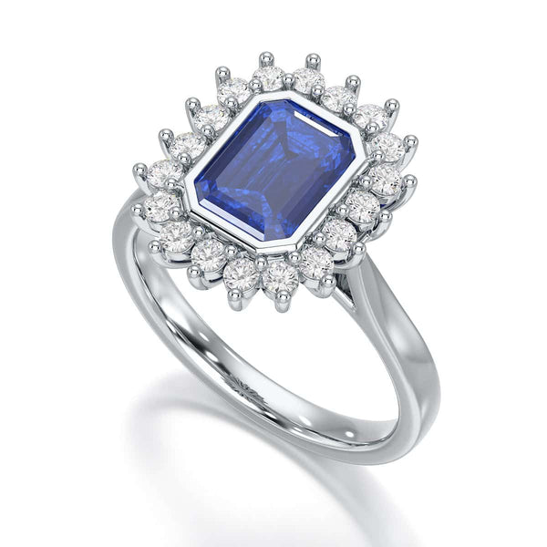 Elegant gold ring with a blue gemstone in a detailed crown setting, viewed from the side, highlighting its intricate design and luxury.