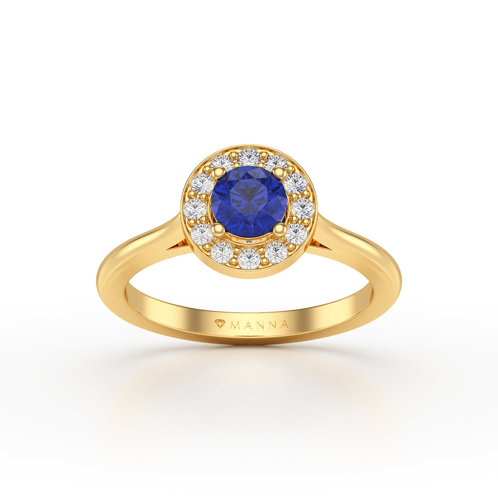 Hand wearing a ring with a blue gemstone