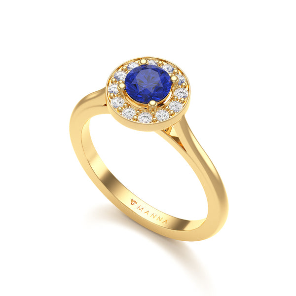 Hand wearing a ring with a blue gemstone