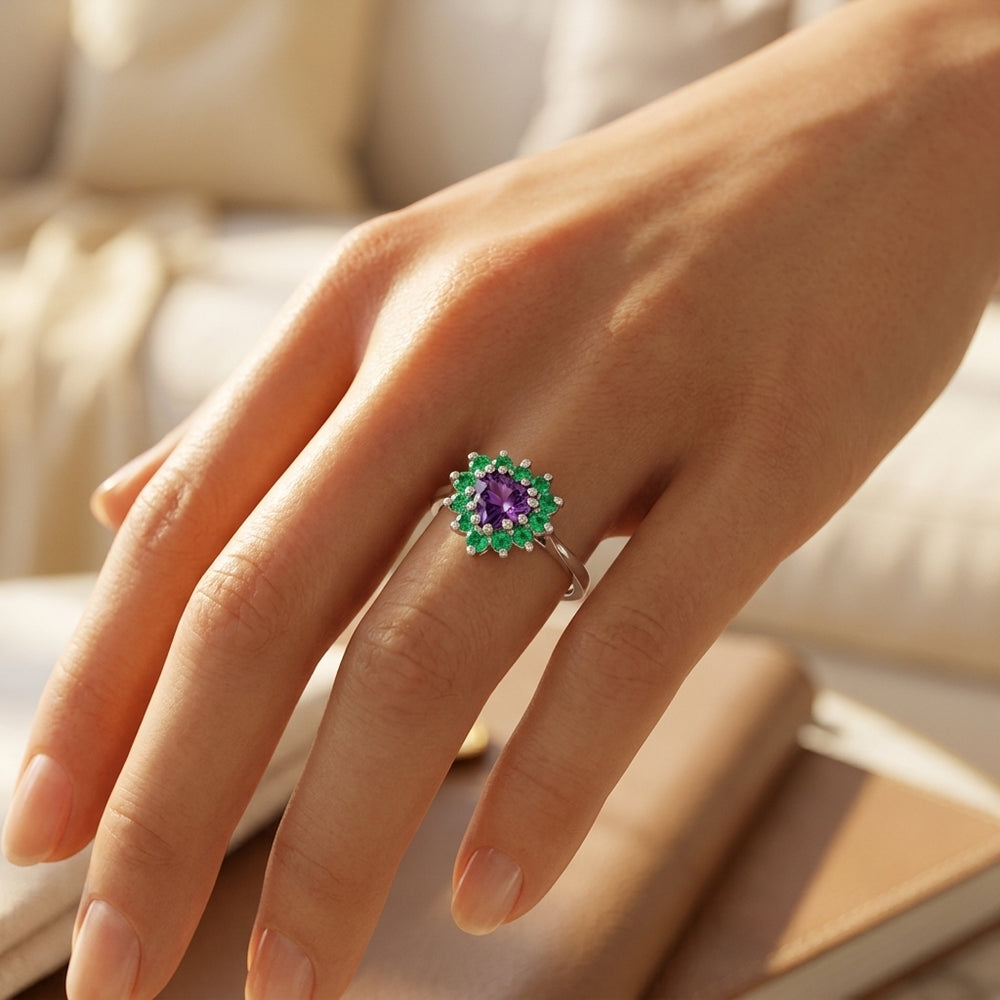 White gold ring with a central purple stone surrounded by green stones in a floral design. The elegant ring reflects luxury and sophistication.