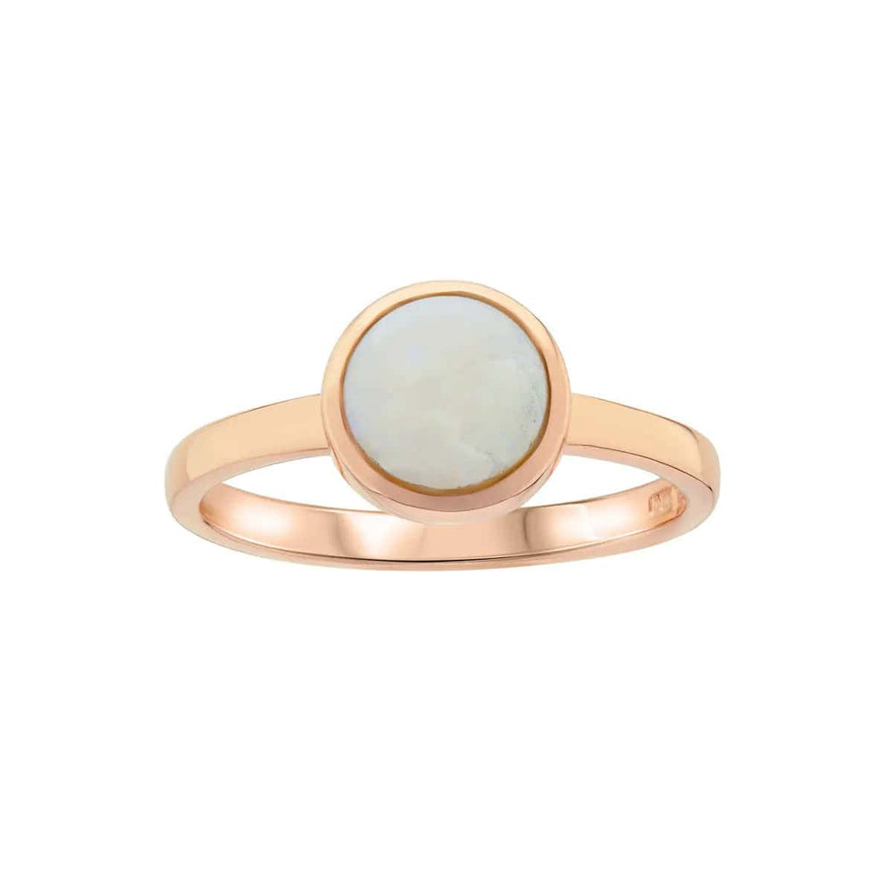 A minimalist white gold ring featuring a smooth round moonstone set in a sleek bezel setting, exuding elegance and simplicity against a plain background.