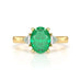 18ct Gold Emerald oval center with trillion shaped diamonds Engagement rings
