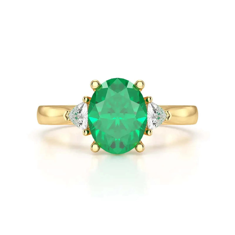 18ct Gold Emerald oval center with trillion shaped diamonds Engagement rings