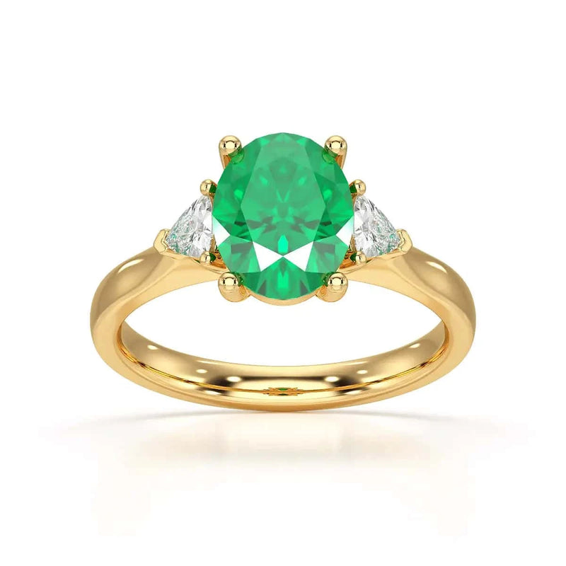 18ct Gold Emerald oval center with trillion shaped diamonds ring