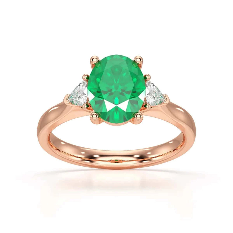 18ct Rose Gold Emerald oval center with trillion shaped diamonds ring