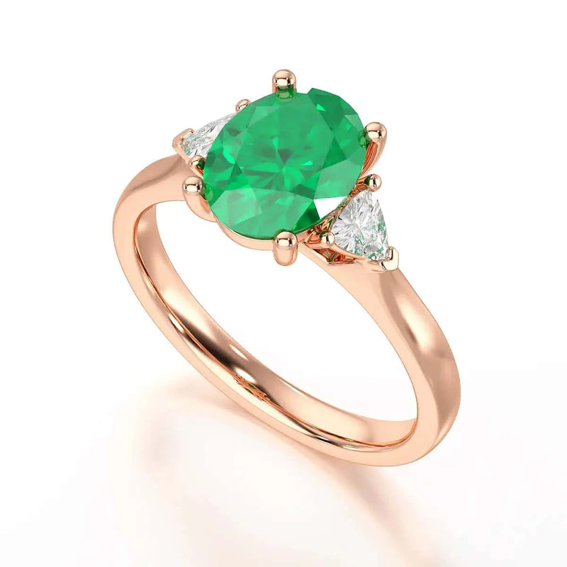 18ct Rose gold Emerald oval center with trillion shaped diamonds Engagement ring