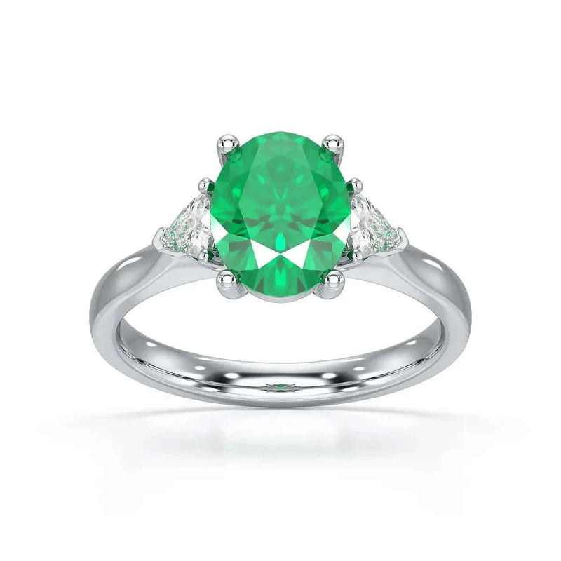 18ct White Gold Emerald oval center with trillion shaped diamonds ring
