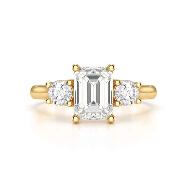 Emerald trilogy Engagement Ring with round side stone