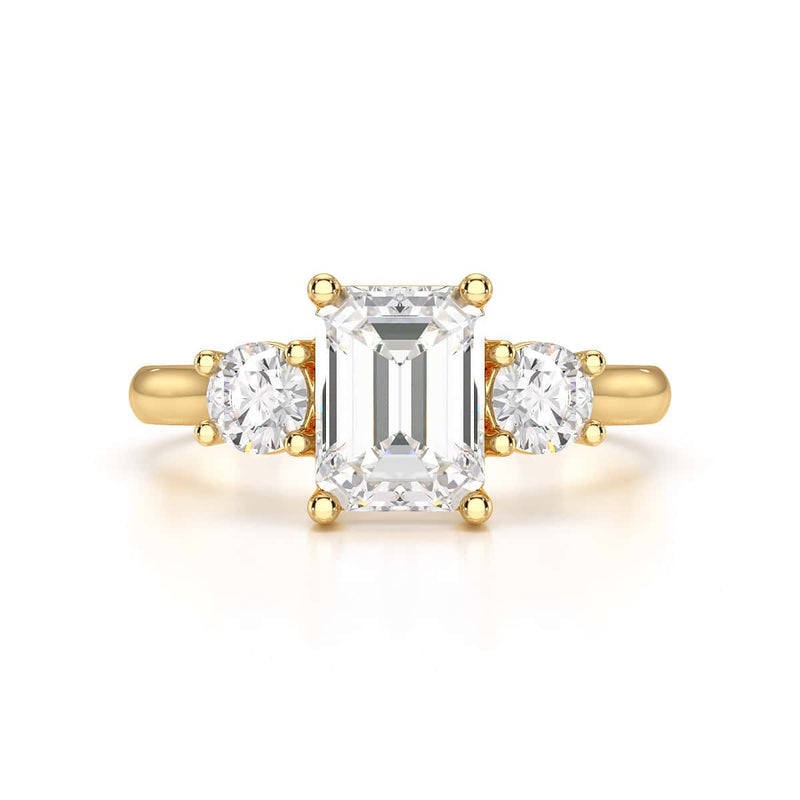 Emerald trilogy Engagement Ring with round side stone