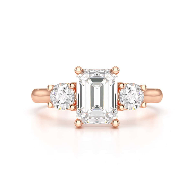 Emerald trilogy Engagement Ring with round side stone