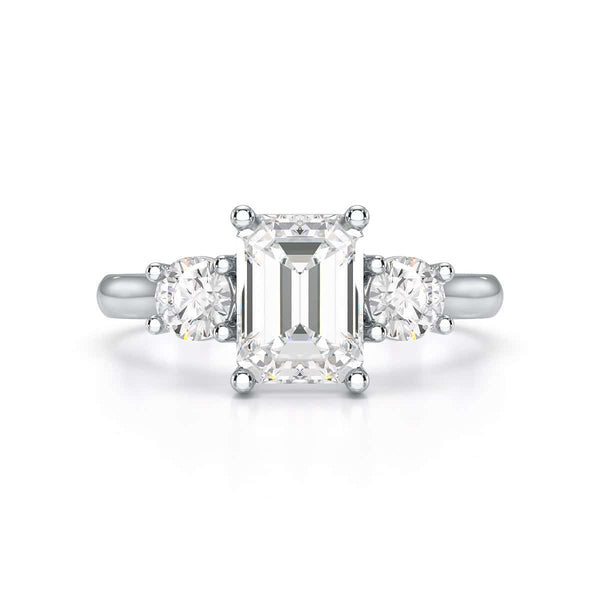 Emerald trilogy Engagement Ring with round side stone