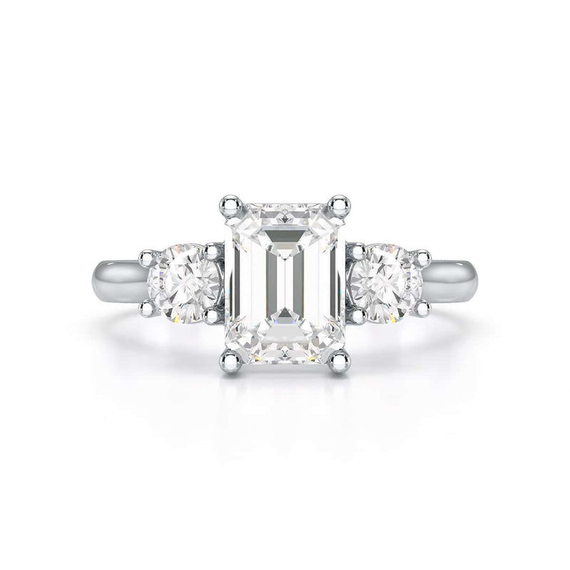 Emerald trilogy Engagement Ring with round side stone