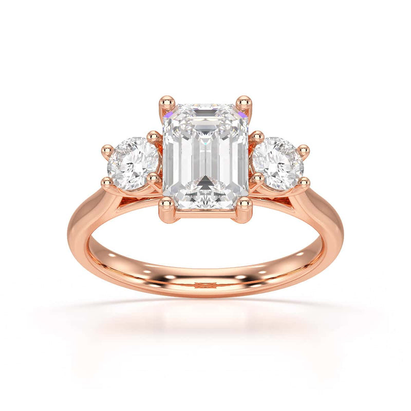 Emerald trilogy Engagement Ring with round side stone