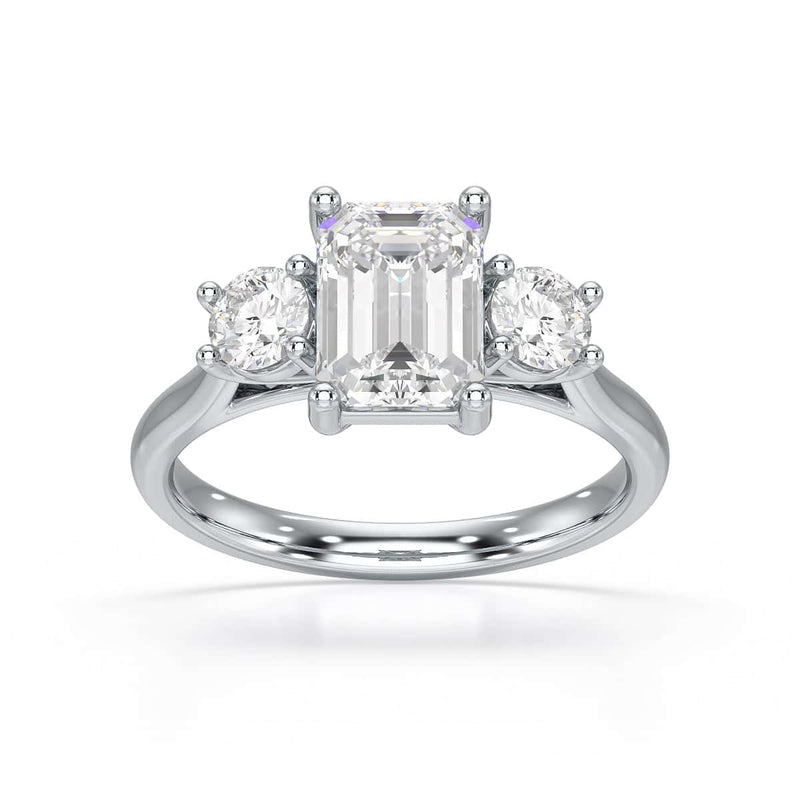 Emerald trilogy Engagement Ring with round side stone