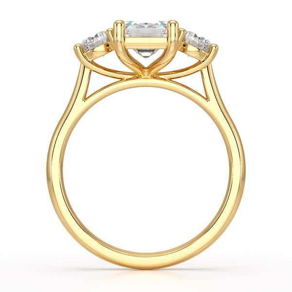 Emerald trilogy Engagement Ring with round side stone