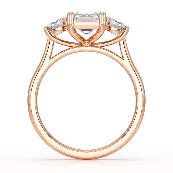 Emerald trilogy Engagement Ring with round side stone