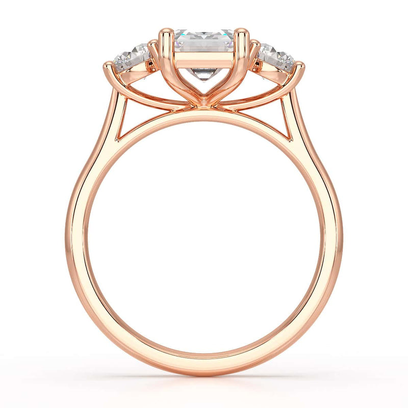 Emerald trilogy Engagement Ring with round side stone