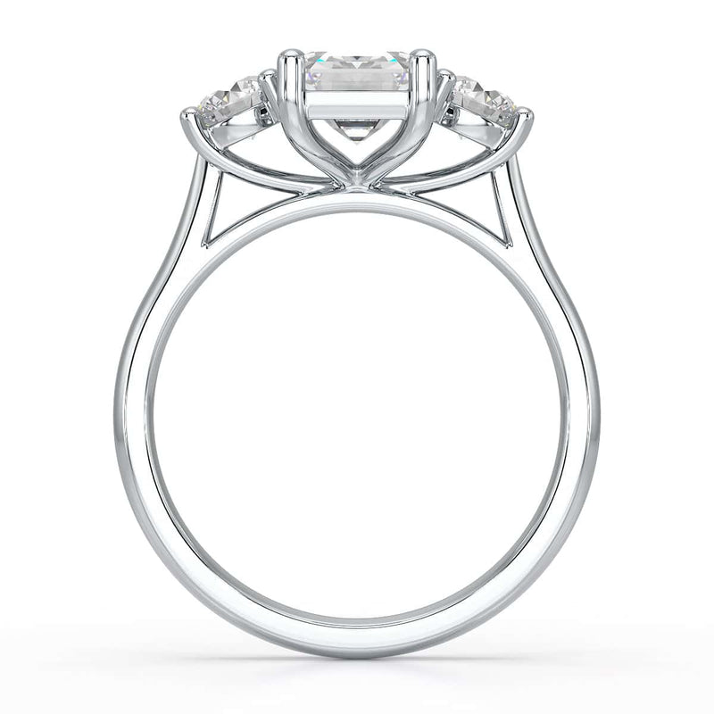 Emerald trilogy Engagement Ring with round side stone