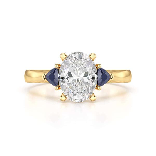 Oval trilogy engagement ring with trillion shaped blue sapphire side stones