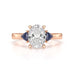 Oval trilogy engagement ring with trillion shaped blue sapphire side stones