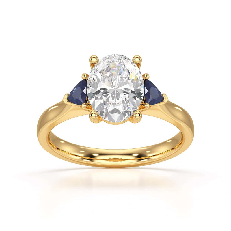 Oval trilogy engagement ring with trillion shaped blue sapphire side stones