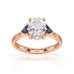Oval trilogy engagement ring with trillion shaped blue sapphire side stones
