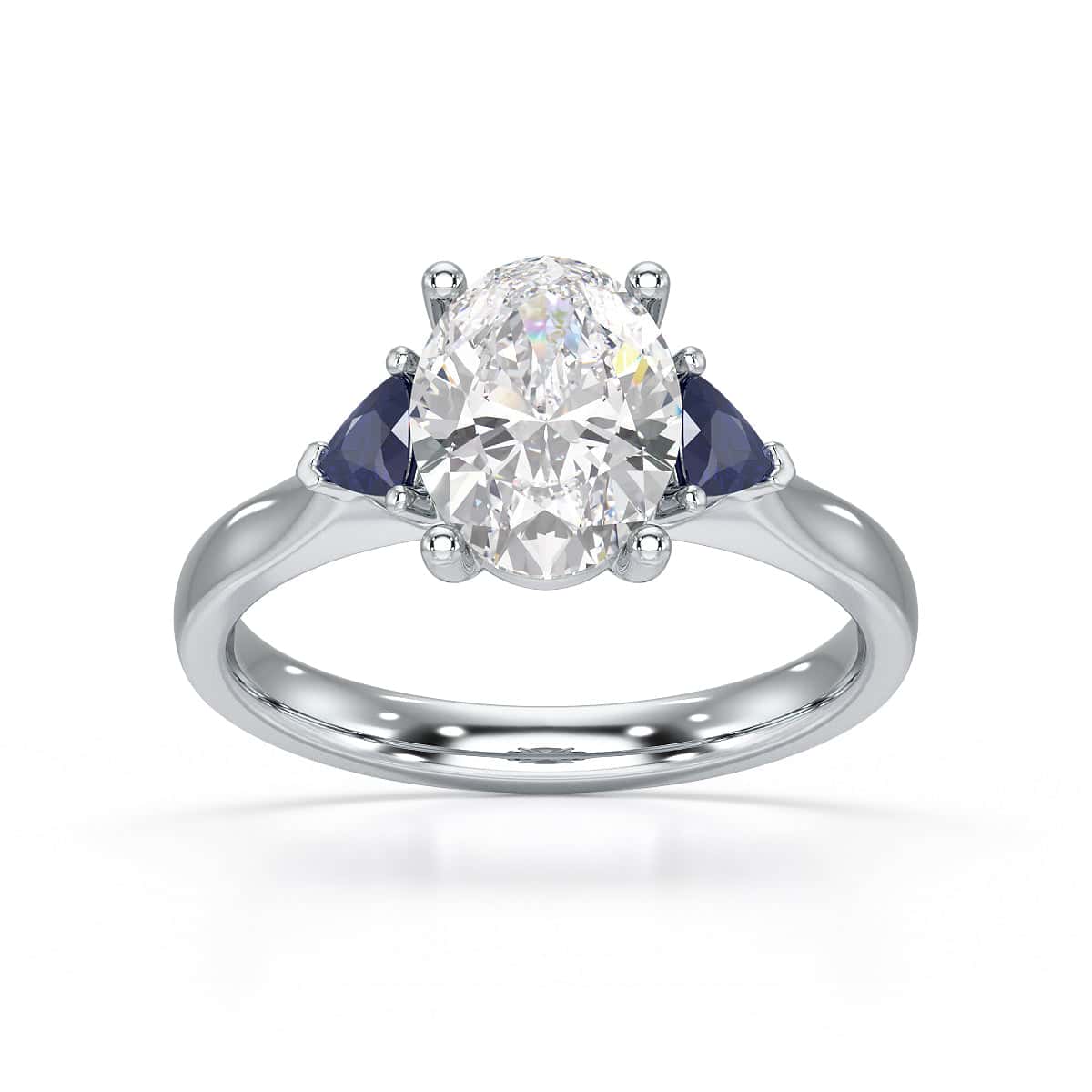 Oval trilogy engagement ring with trillion shaped blue sapphire side stones