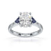 Oval trilogy engagement ring with trillion shaped blue sapphire side stones