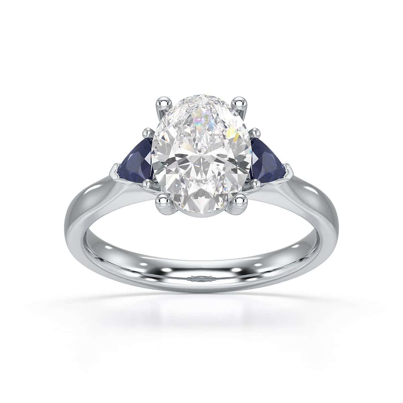 Oval trilogy engagement ring with trillion shaped blue sapphire side stones