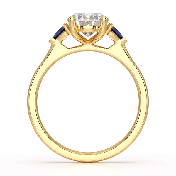 Oval trilogy engagement ring with trillion shaped blue sapphire side stones