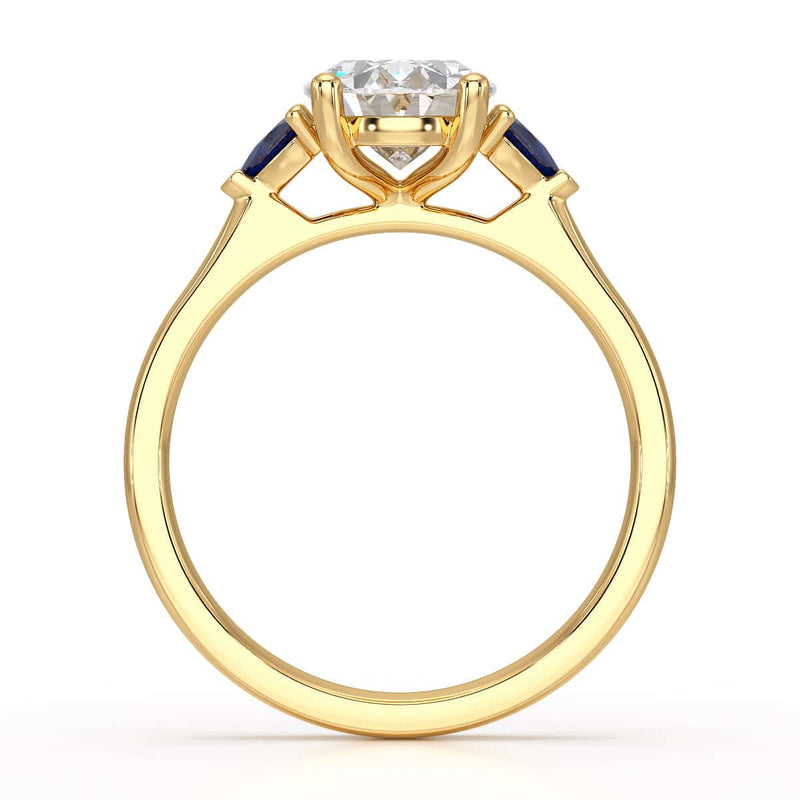 Oval trilogy engagement ring with trillion shaped blue sapphire side stones