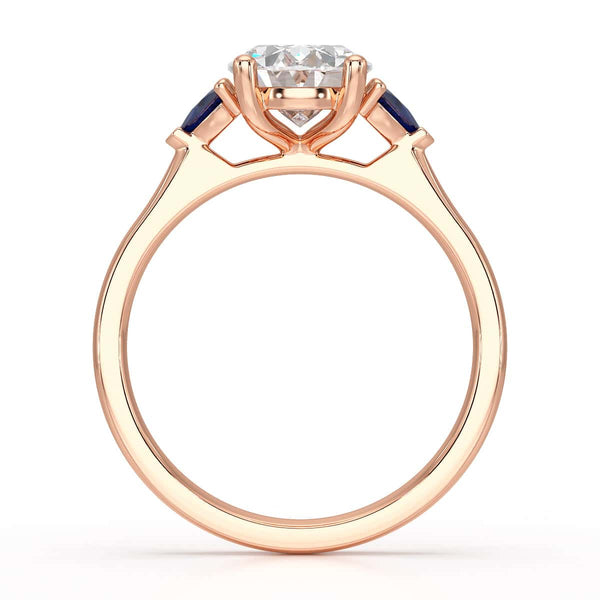 Oval trilogy engagement ring with trillion shaped blue sapphire side stones