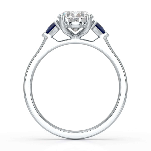 Oval trilogy engagement ring with trillion shaped blue sapphire side stones