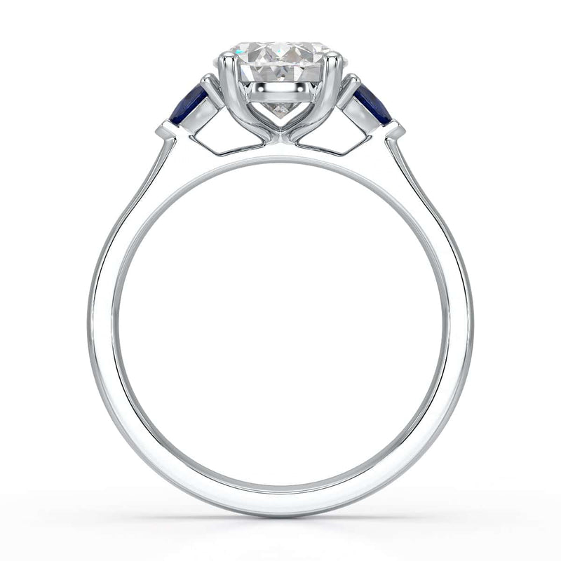 Oval trilogy engagement ring with trillion shaped blue sapphire side stones