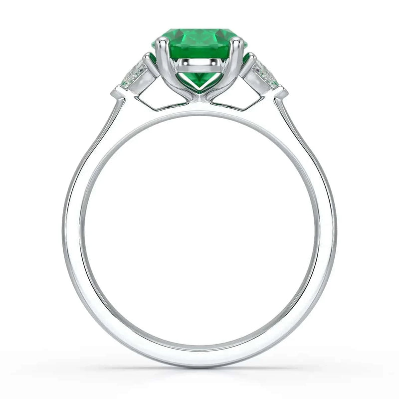 Platinum Emerald oval center with trillion shaped diamonds Engagement  ring